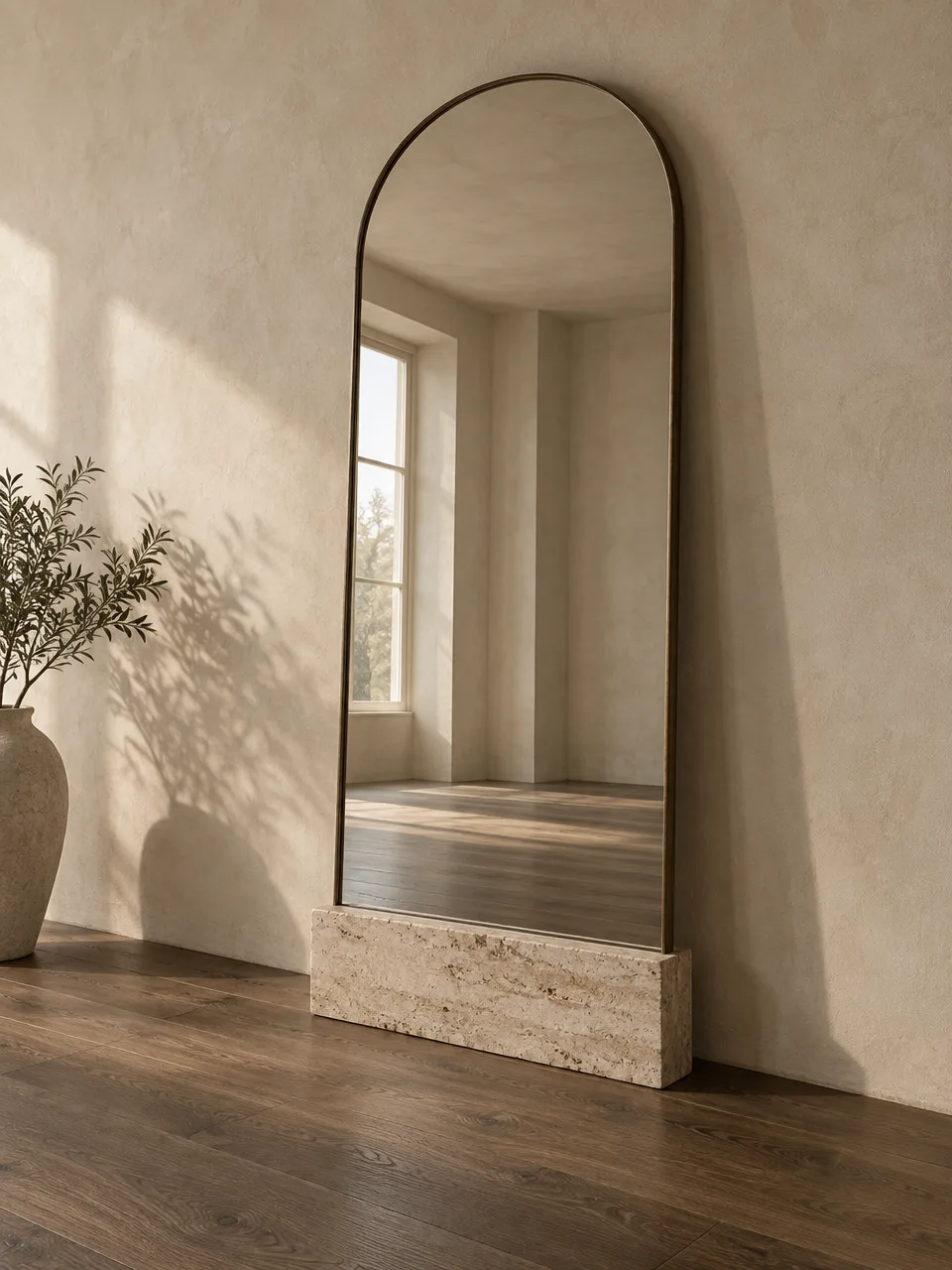 Arched floor mirror in a bronze frame on a travertine base