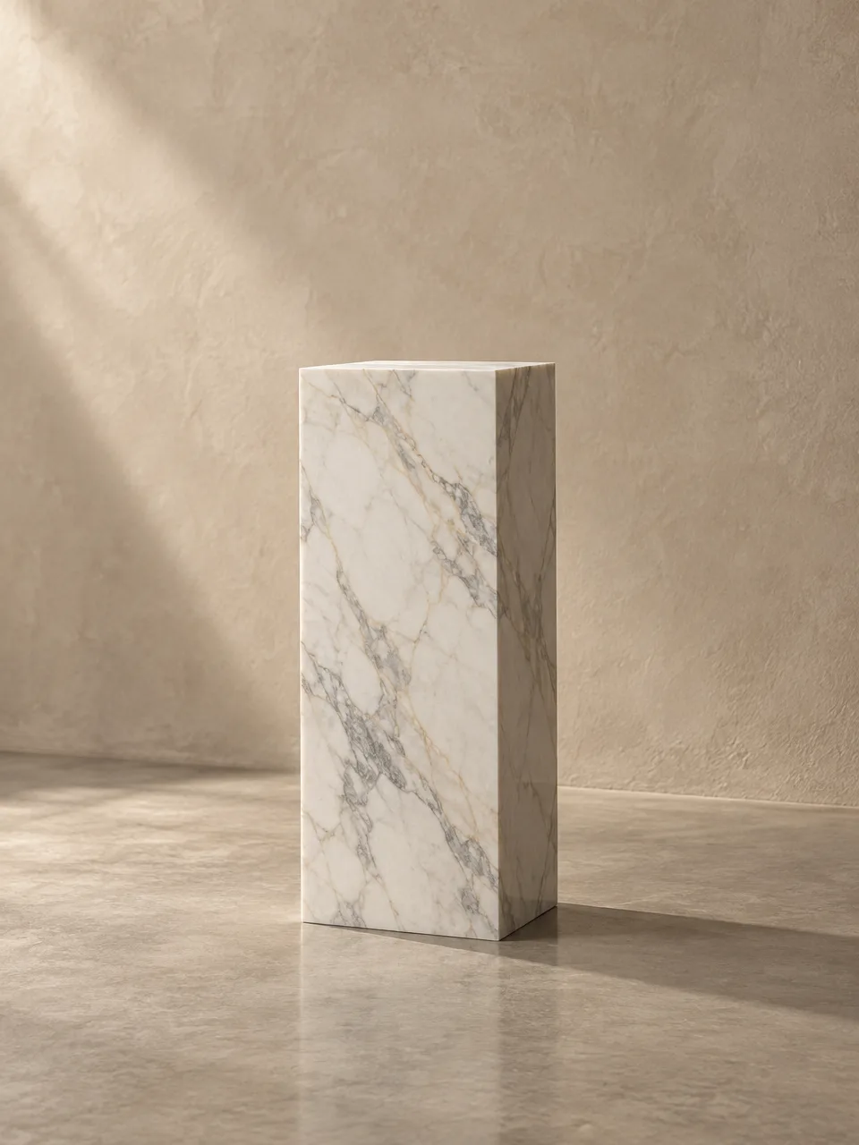 Square-section marble pedestal against a plaster wall
