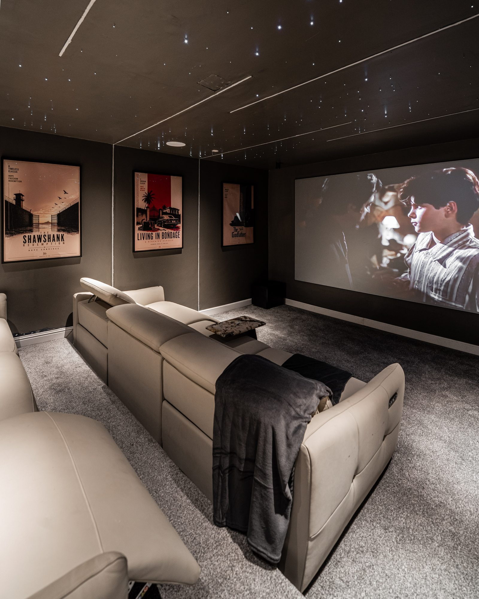 Home cinema with a star-field ceiling and leather recliners