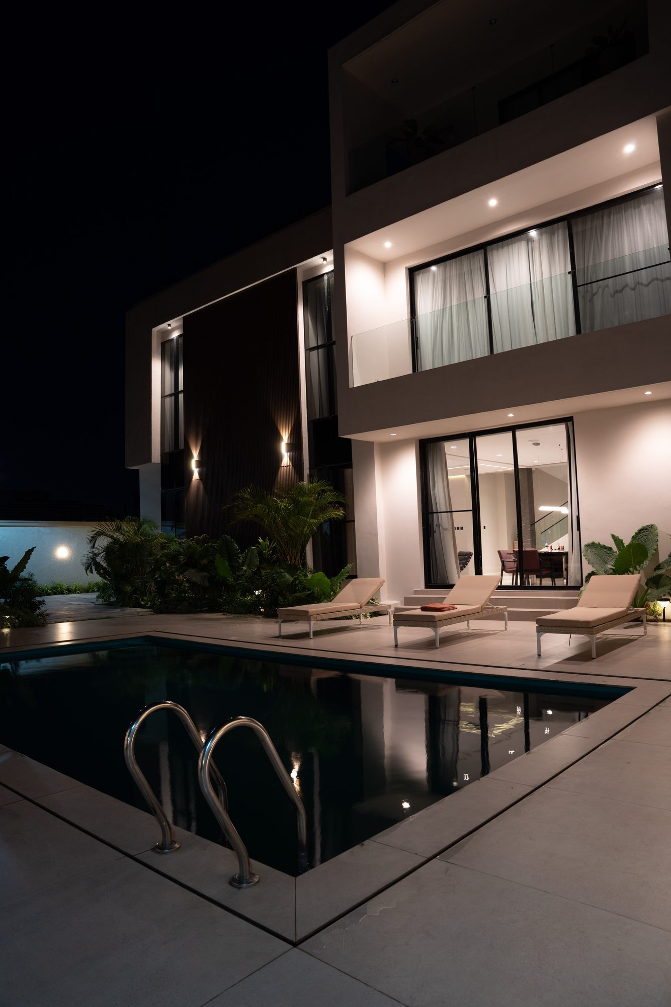 The house at night from the pool corner