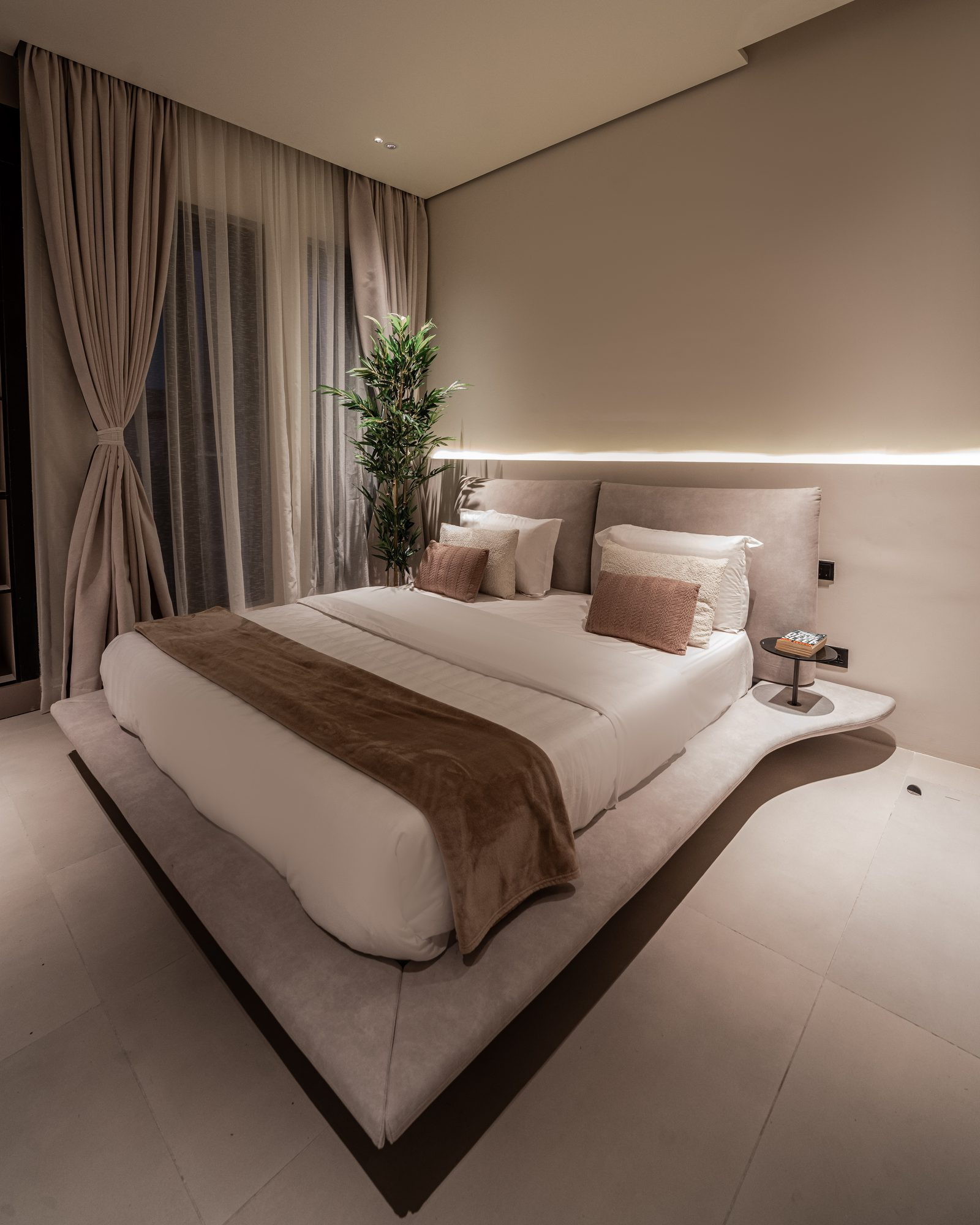 Guest bedroom with a floating bed and soft curtains