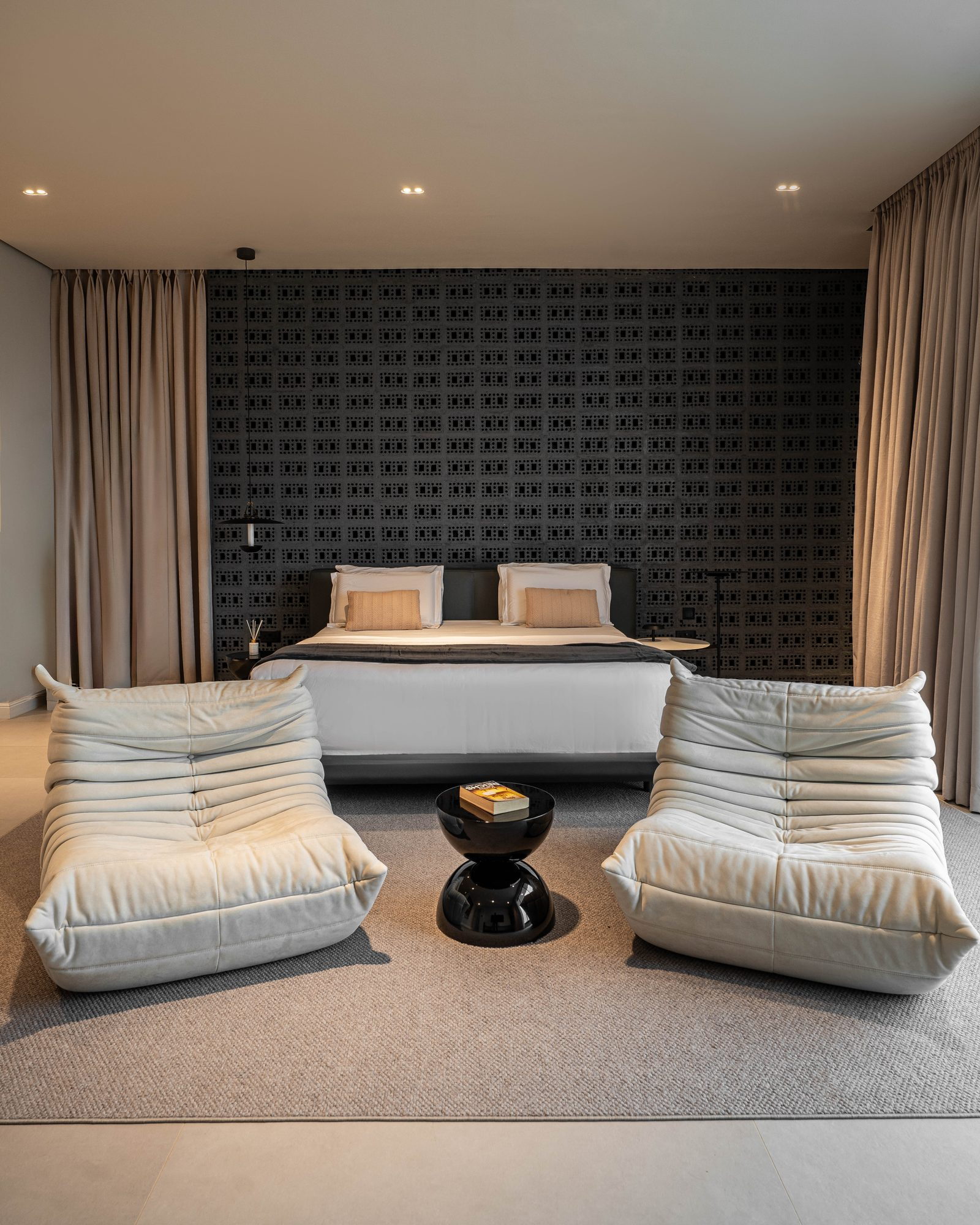 Principal bedroom from the foot of the bed, the charcoal screen wall behind